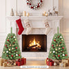 Two pre-lit mini Christmas trees with 50 warm white LED lights and snow-dusted tips flank a festive fireplace scene.
