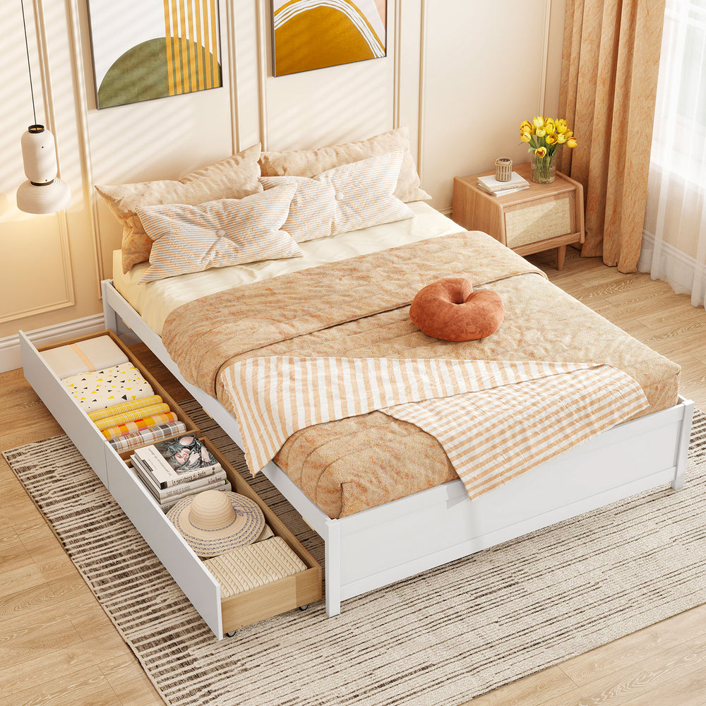Queen size bed frame in white with two rolling storage drawers, featuring a cozy bedding setup for stylish bedroom.