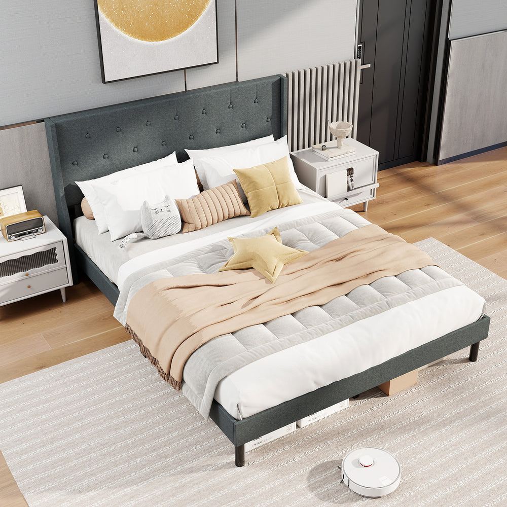 Queen size upholstered bed frame in gray with button tufted wingback headboard, featuring wooden slats for mattress.