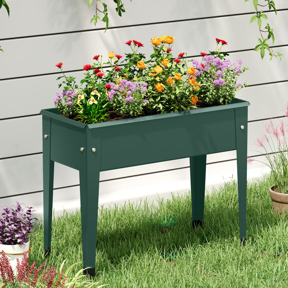 Elevated green metal gardening box with flowers, featuring drainage holes and a sturdy design for easy planting.