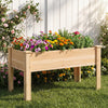 Raised garden bed made of solid fir wood, featuring vibrant flowers and herbs, ideal for outdoor planting.