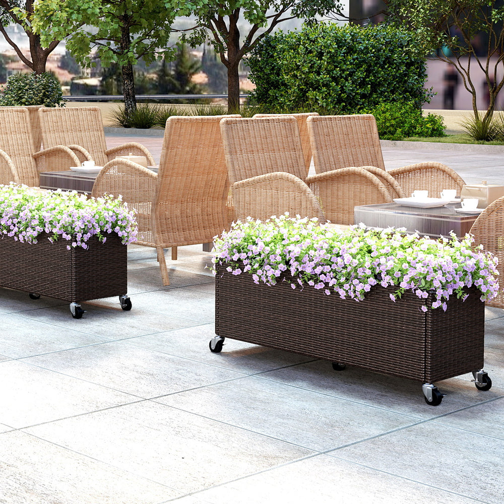 Raised garden bed planter box made of PE rattan with wheels, ideal for outdoor patios and cultivating flowers.