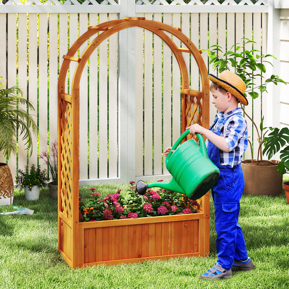 Wooden raised garden bed with lattice trellis and arched roof, perfect for climbing plants and flowers in a backyard.