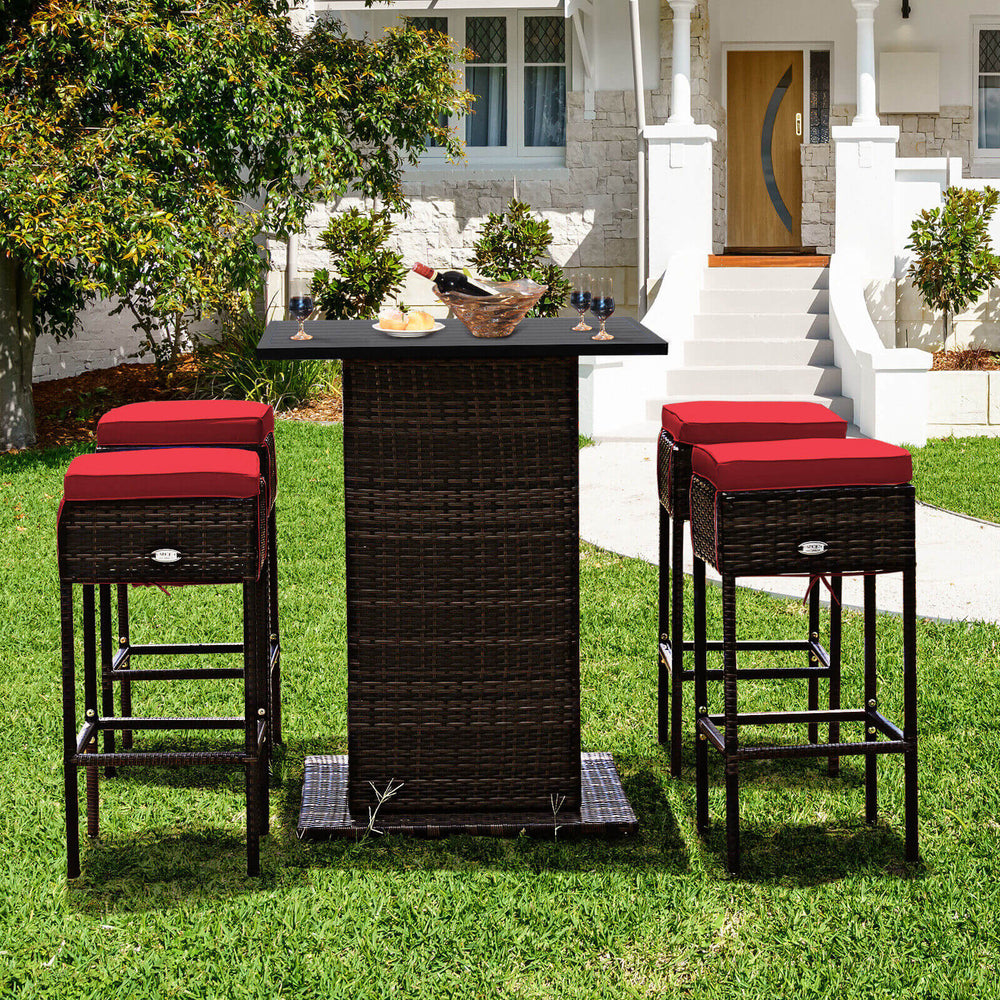 5-piece patio rattan bar table set with red cushioned stools, featuring hidden storage, perfect for outdoor leisure.