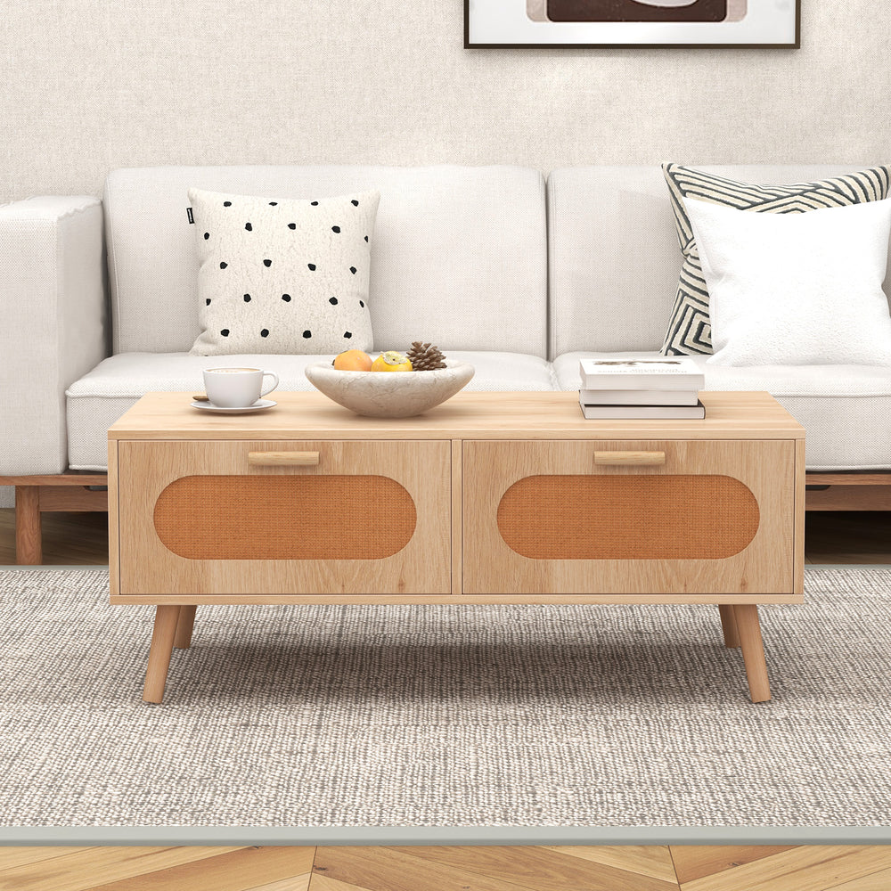 Mid-century modern rattan coffee table with two storage drawers, natural wood finish, perfect for stylish living room.