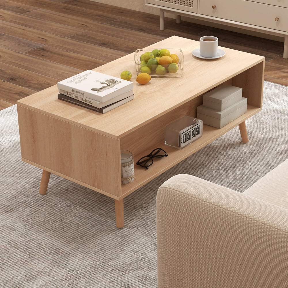 Mid-century modern rattan coffee table with natural wood finish, featuring ample storage and elegant raised legs for.