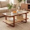 Rattan coffee table with tempered glass top and storage shelf in walnut finish, styled with decor and fruit bowl.