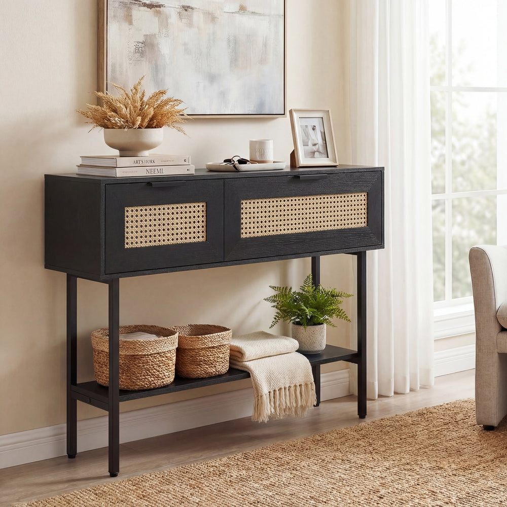 Rattan console table with a wide top and open shelf, showcasing a black carbon steel frame for versatile storage.