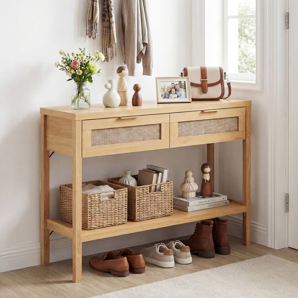 Natural rattan console table with two drawers and bottom shelf, ideal for decorative display and organized storage.