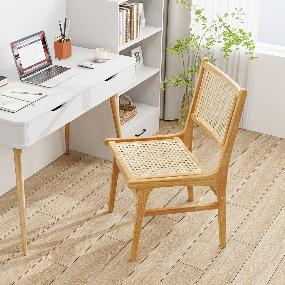 Rattan dining chair with natural cane backrest and teak wood frame, ideal for stylish indoor dining spaces.