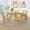 Rattan dining chair with natural cane backrest and teak wood frame, offering stability and comfort in a stylish setting.
