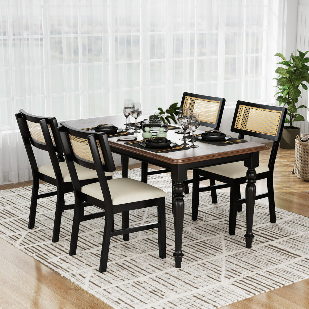 Black rattan dining chairs with padded seats, featuring rubber wood legs, arranged around a dining table for a stylish.