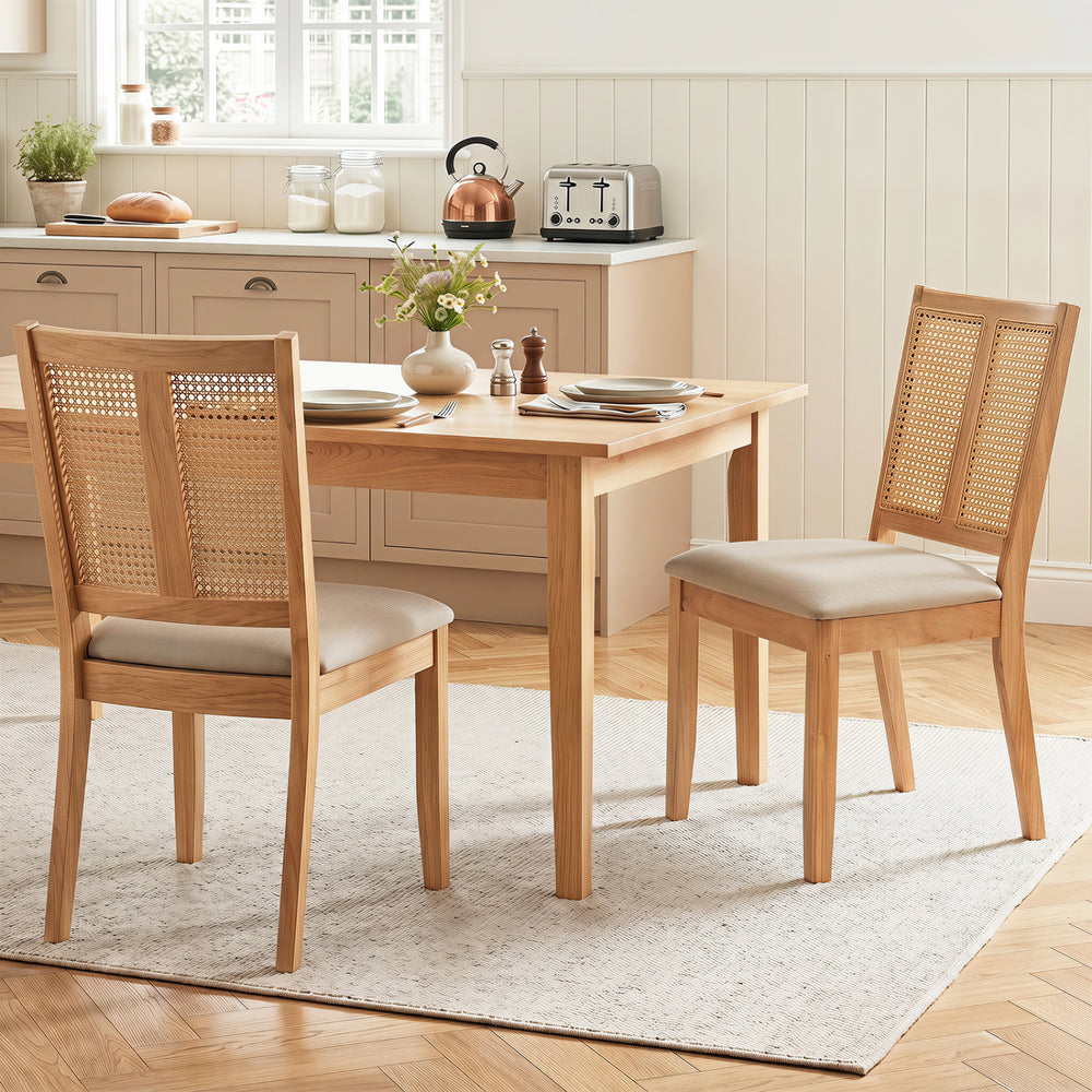 Curved backrest rattan dining chairs set of 2 with padded seats in natural wood finish for dining rooms and kitchens.