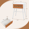 Mid-century modern rattan nightstand with a white finish and spacious drawer, ideal for stylish bedroom storage.