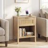 Rattan nightstand in oak with charging station, spacious drawer, and open shelf for organized bedside storage.