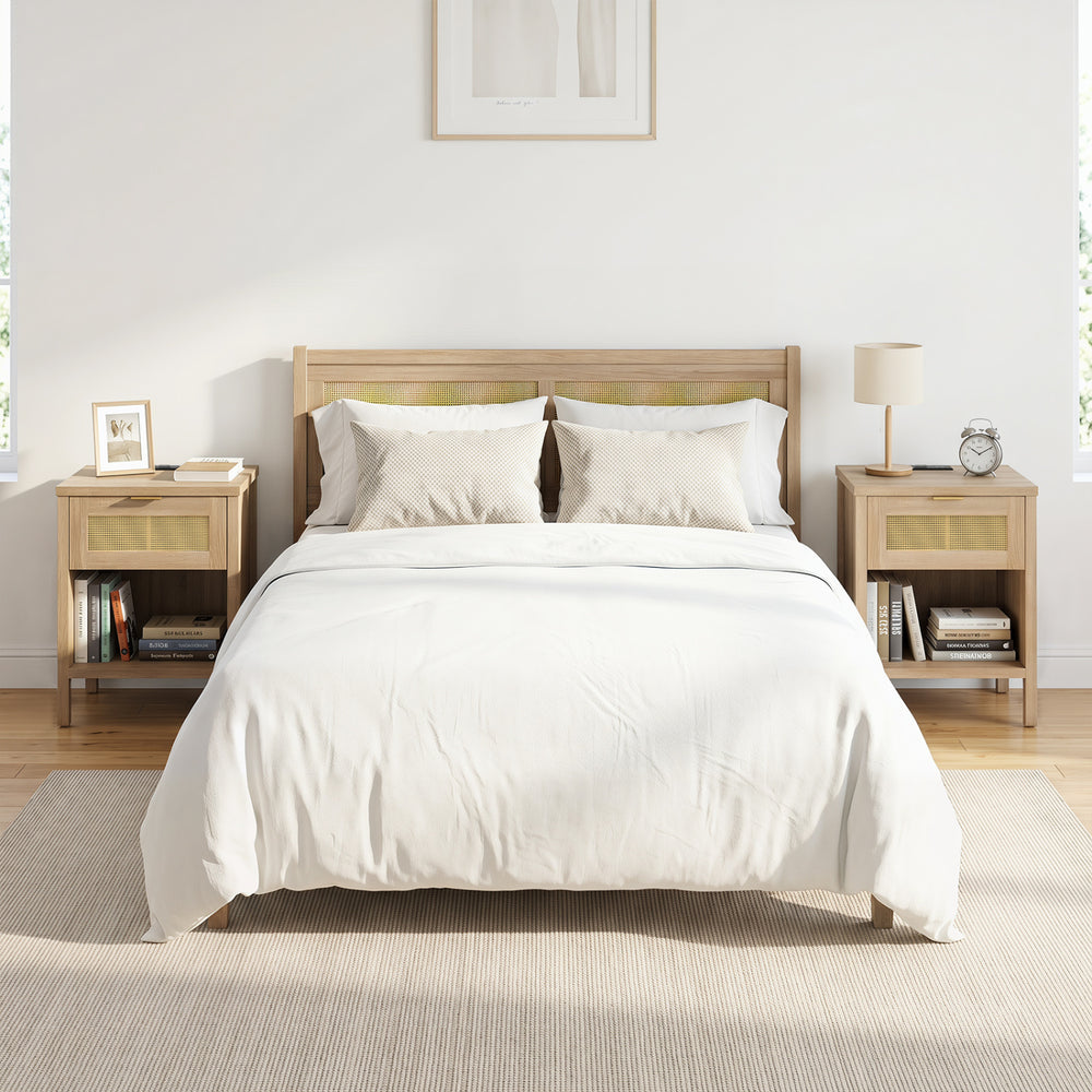 Rattan nightstand with charging station, spacious drawer, and open shelf, featuring oak finish for bedroom organization.