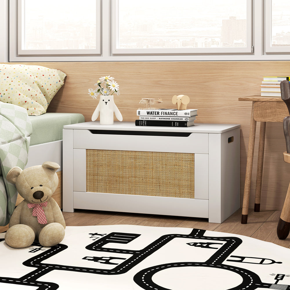 Kids rattan toy storage box in white with flip top lid and safety hinge, perfect for organizing toys in a child's room.