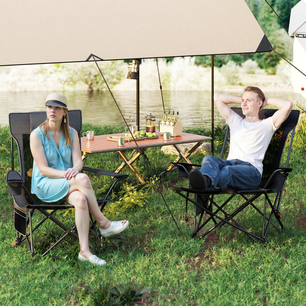 Two campers relaxing in gray reclining chairs with removable footrests and adjustable backrests by a lakeside.