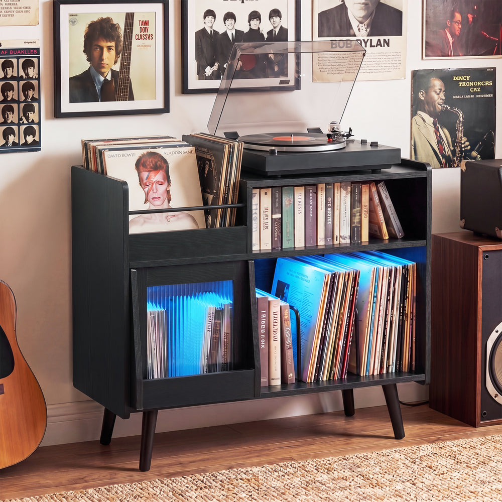 Record player stand in black with LED light, power outlets, and storage for vinyl records in a stylish living room.