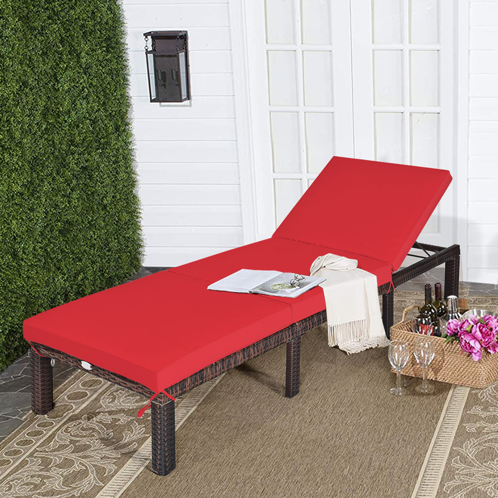 Red cushioned outdoor rattan chaise lounge with adjustable backrest for patio and poolside relaxation.