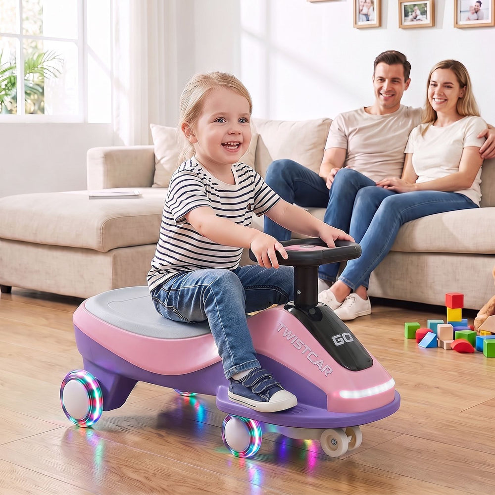 Ride-on car in pink with flashing wheels, front light, and music speaker, designed for children aged 3+ for indoor and outdoor fun.
