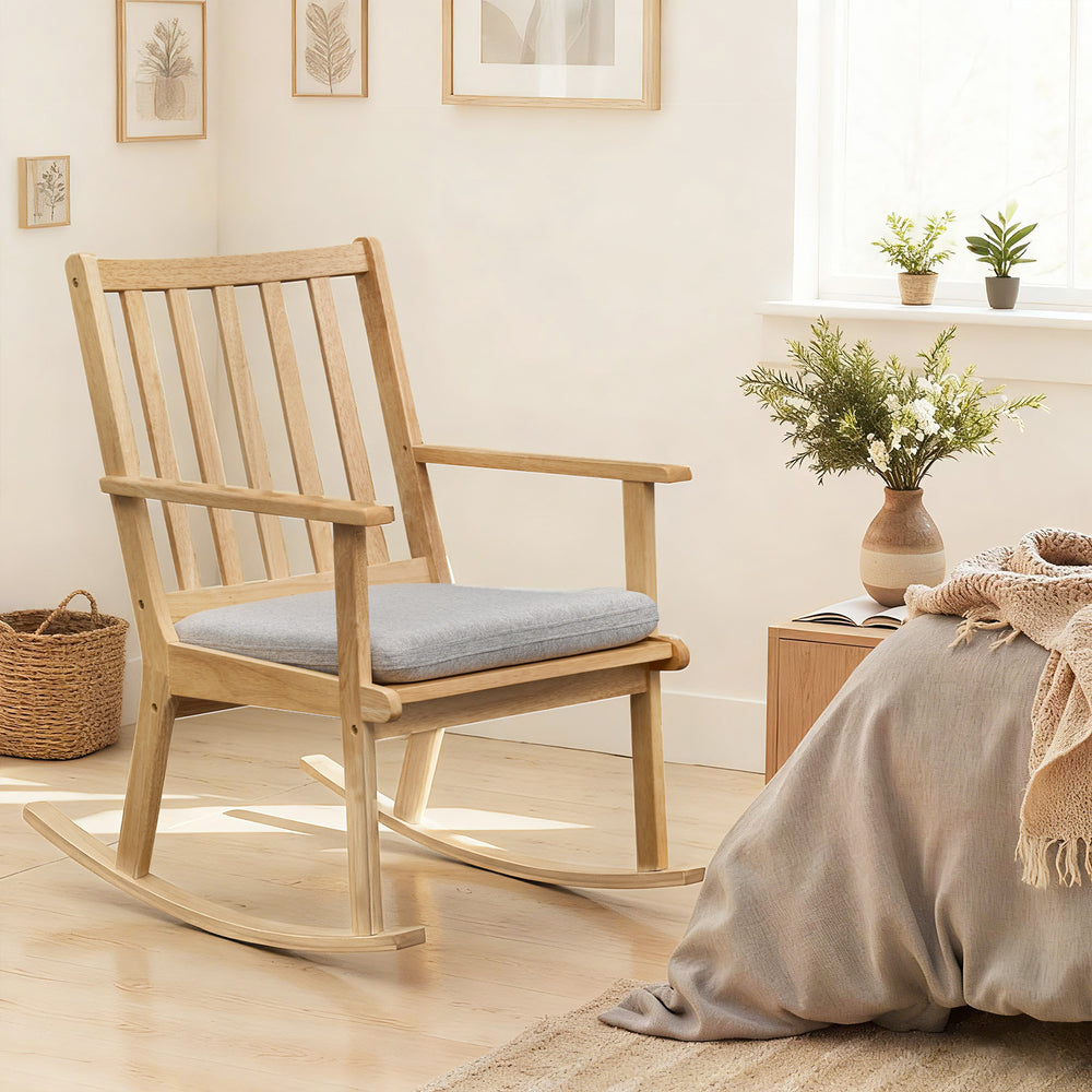 Natural rubber wood rocking chair with padded seat cushion, perfect for reading and relaxation in any room.