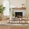 Natural solid rubber wood rocking chair with padded seat and ergonomic backrest, perfect for relaxing by the fireplace.