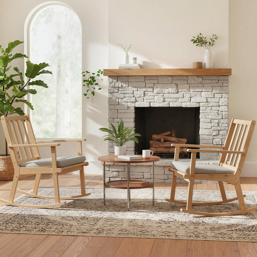 Natural solid rubber wood rocking chair with padded seat and ergonomic backrest, perfect for relaxing by the fireplace.
