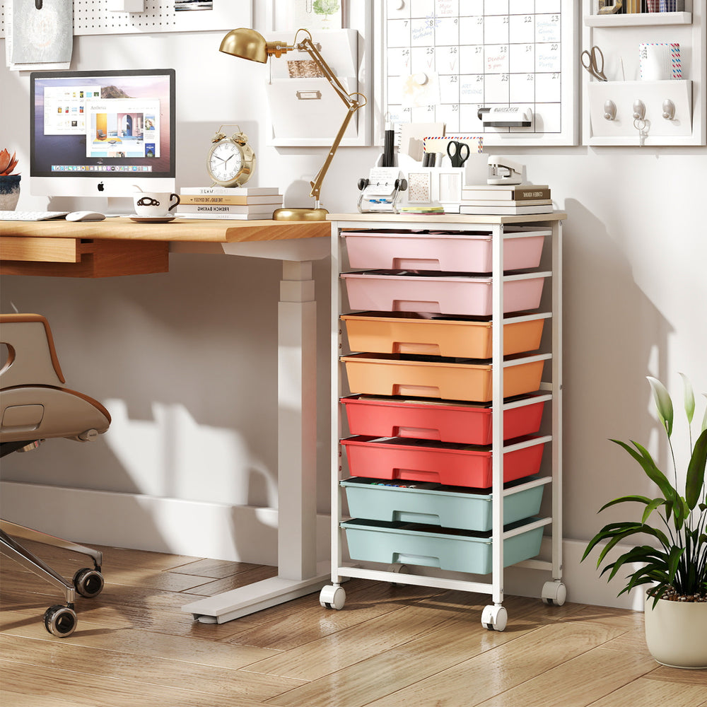 Rolling cart with 8 drawers in various colors, featuring a sturdy metal frame and foldable side panels for extra workspace.