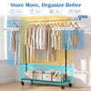 Rolling clothes rack with extendable rods and bottom storage bars, ideal for organizing clothes in any room.