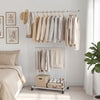 Double-rod rolling clothes rack with extendable top rod, adjustable height, and wheels for easy mobility in any room.