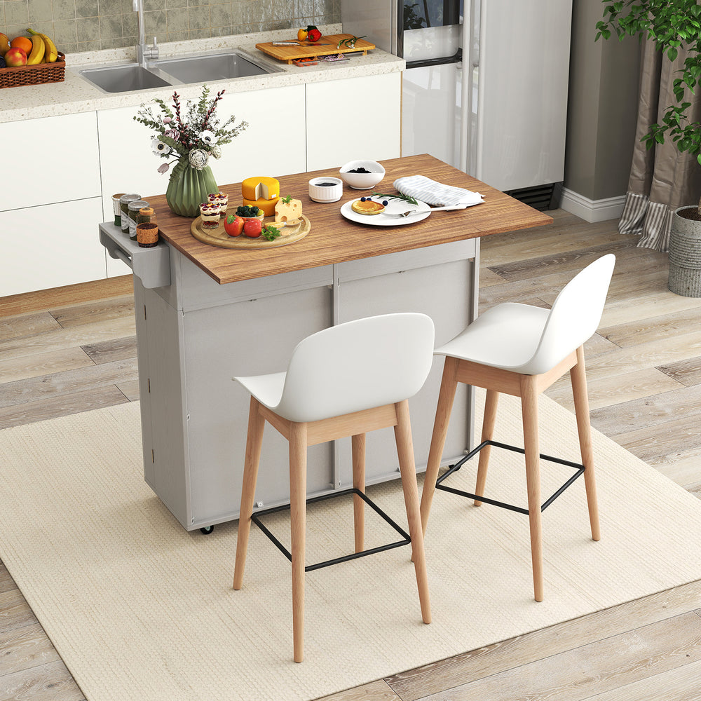Rolling kitchen island with a spacious drop leaf top, storage drawers, and trash can cabinet, perfect for versatile.