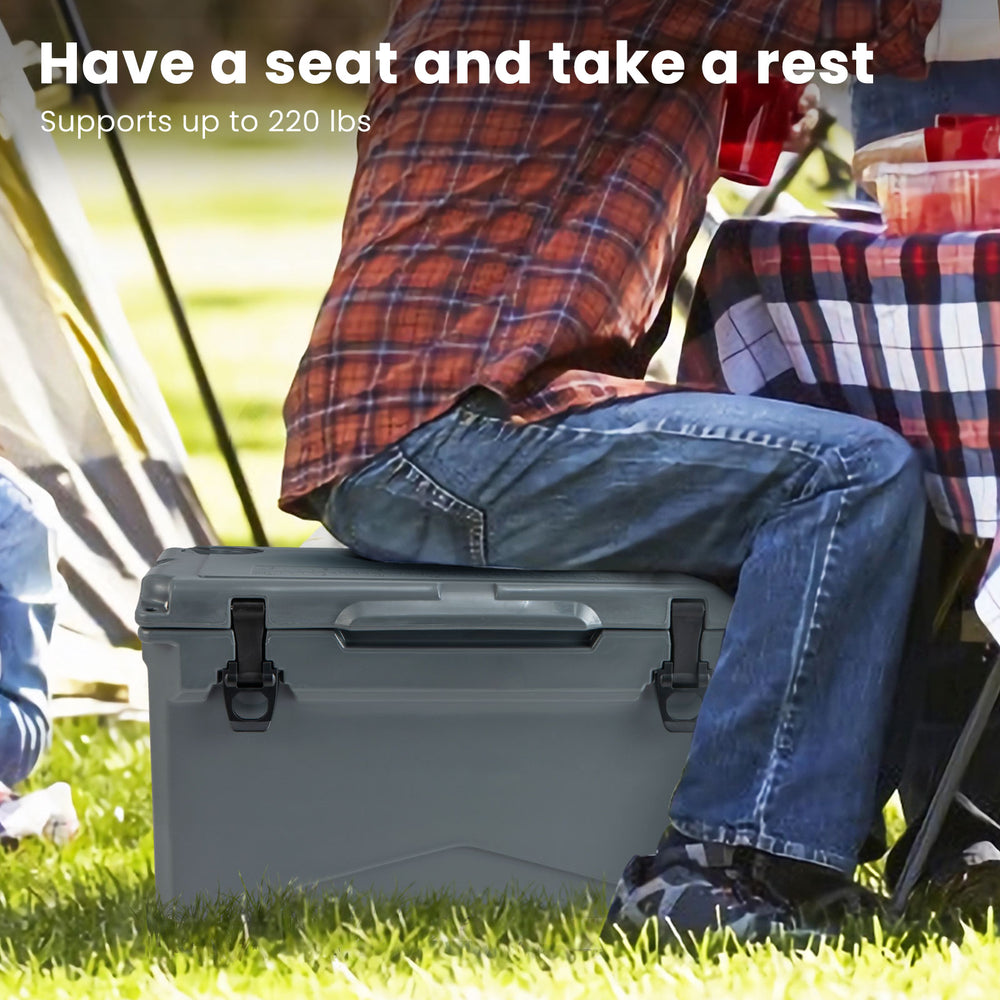Gray rotomolded cooler with integrated cup holders, supporting up to 220 lbs, ideal for camping or outdoor use.