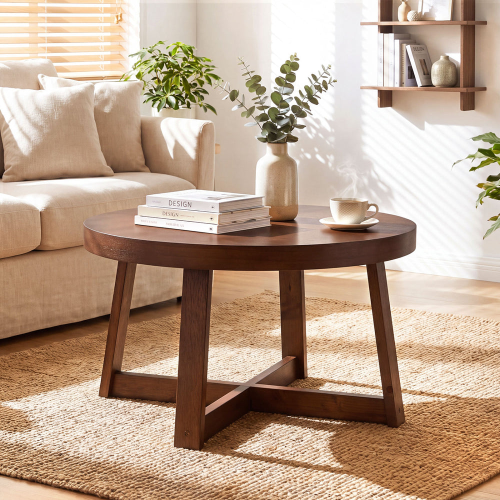 Round coffee table with walnut finish and sturdy rubber wood legs, perfect for organizing items in a living room.