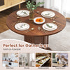 Round walnut dining table with pedestal base, seating 4-6 people, perfect for gatherings in kitchens or restaurants.