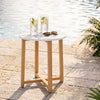 Round end table with a 16" faux marble top and acacia wood legs, ideal for outdoor use by the poolside.