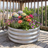 Round galvanized raised garden bed filled with colorful flowers, ideal for patios and balconies, featuring durable.
