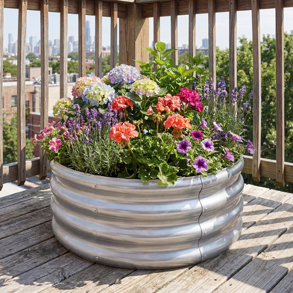 Round galvanized raised garden bed filled with colorful flowers, ideal for patios and balconies, featuring durable.