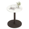 Round marble side table with a stone finish and a black wooden pedestal, perfect for modern living spaces.