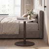 Round marble side table with a wooden base, featuring a stone finish, perfect for bedside use in modern decor.