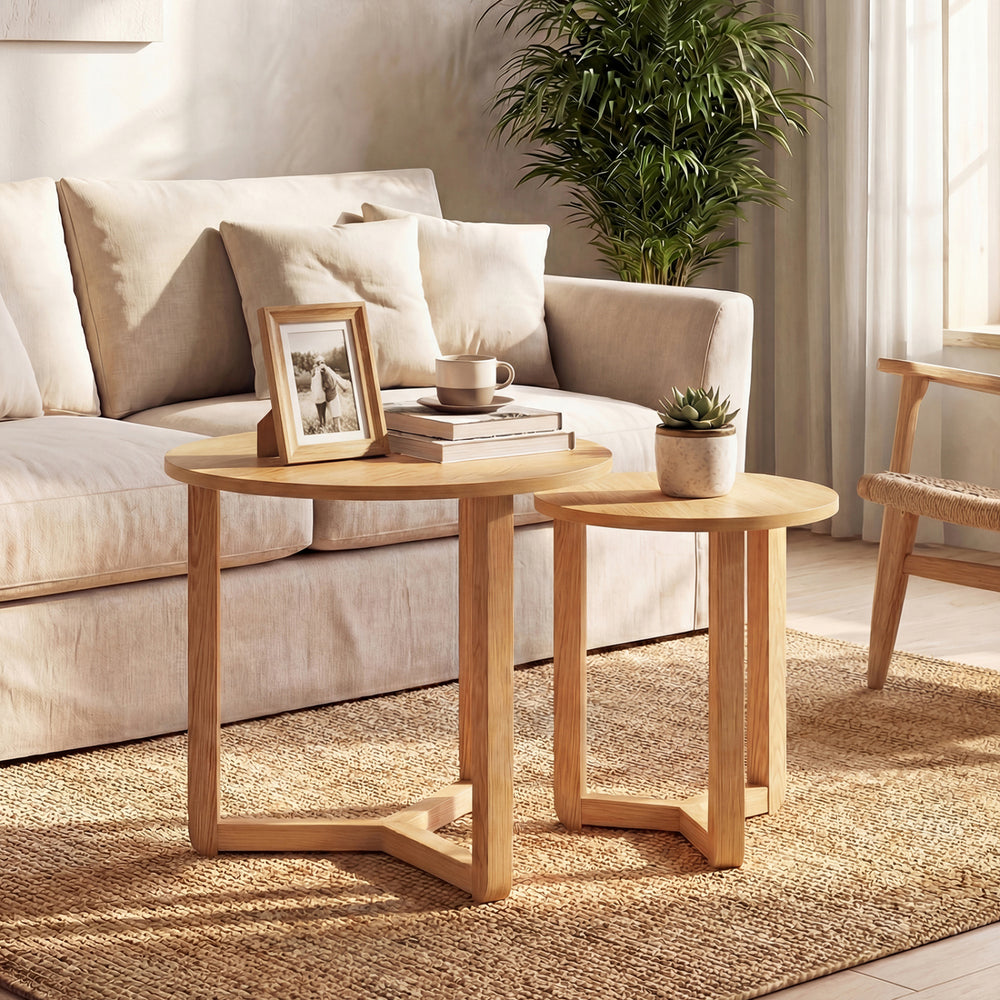 Round nesting coffee table set of 2 in natural rubber wood, featuring spacious tabletops for versatile living room use.