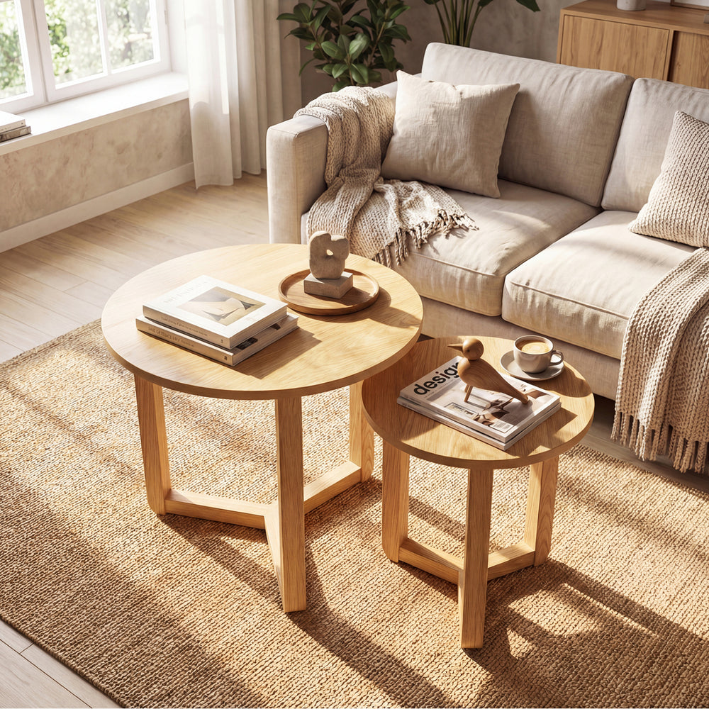 Round nesting coffee table set of 2 in natural wood, featuring spacious tabletops and stable tripod frames for.