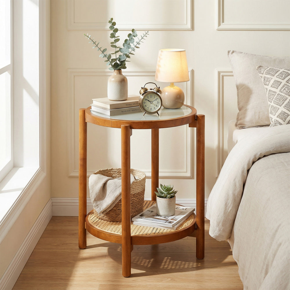 Round side table with tempered glass top and acacia wood legs, featuring 2-tier storage for bedroom or living room use.
