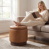 Round storage ottoman in brown faux leather with acacia wood frame, featuring hidden storage and 360° swivel for.