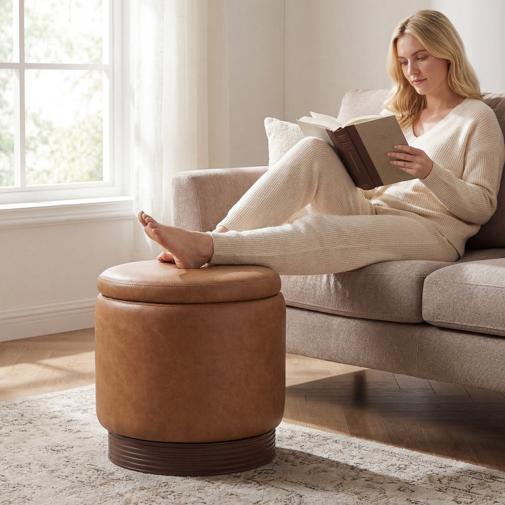 Round storage ottoman in brown faux leather with acacia wood frame, featuring hidden storage and 360° swivel for.