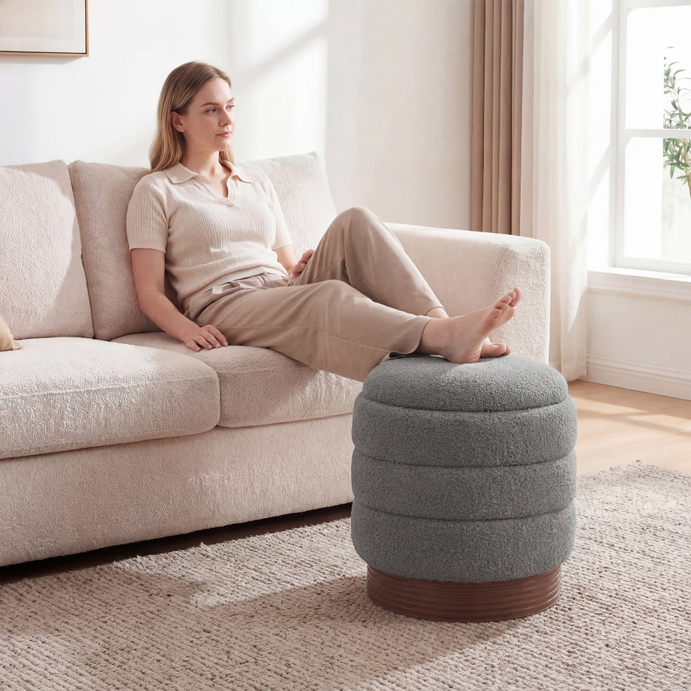 Round gray storage ottoman with acacia wood frame, featuring 360° swivel and hidden storage for living room convenience.