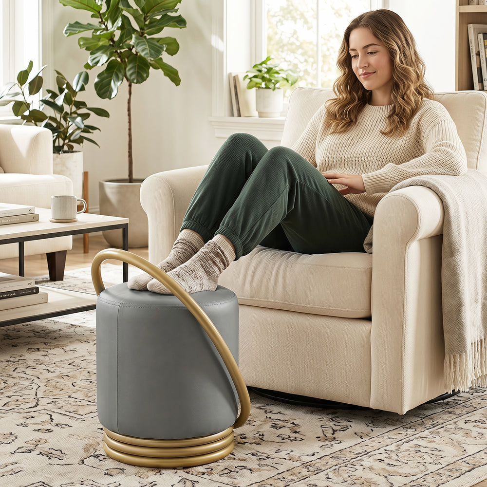 Round grey vanity stool with gold halo design, upholstered in faux leather, perfect for makeup rooms and living spaces.