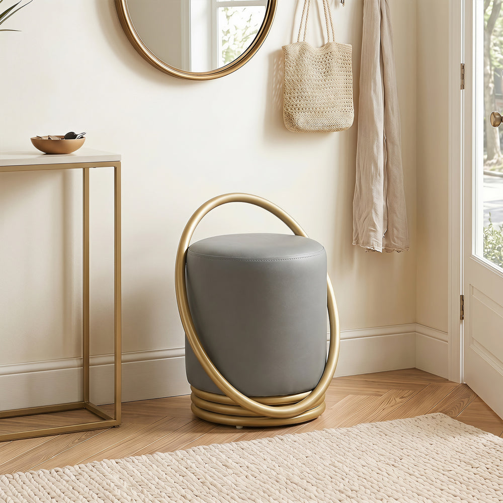 Round vanity stool in grey faux leather with a gold halo design, perfect for makeup rooms and stylish living spaces.