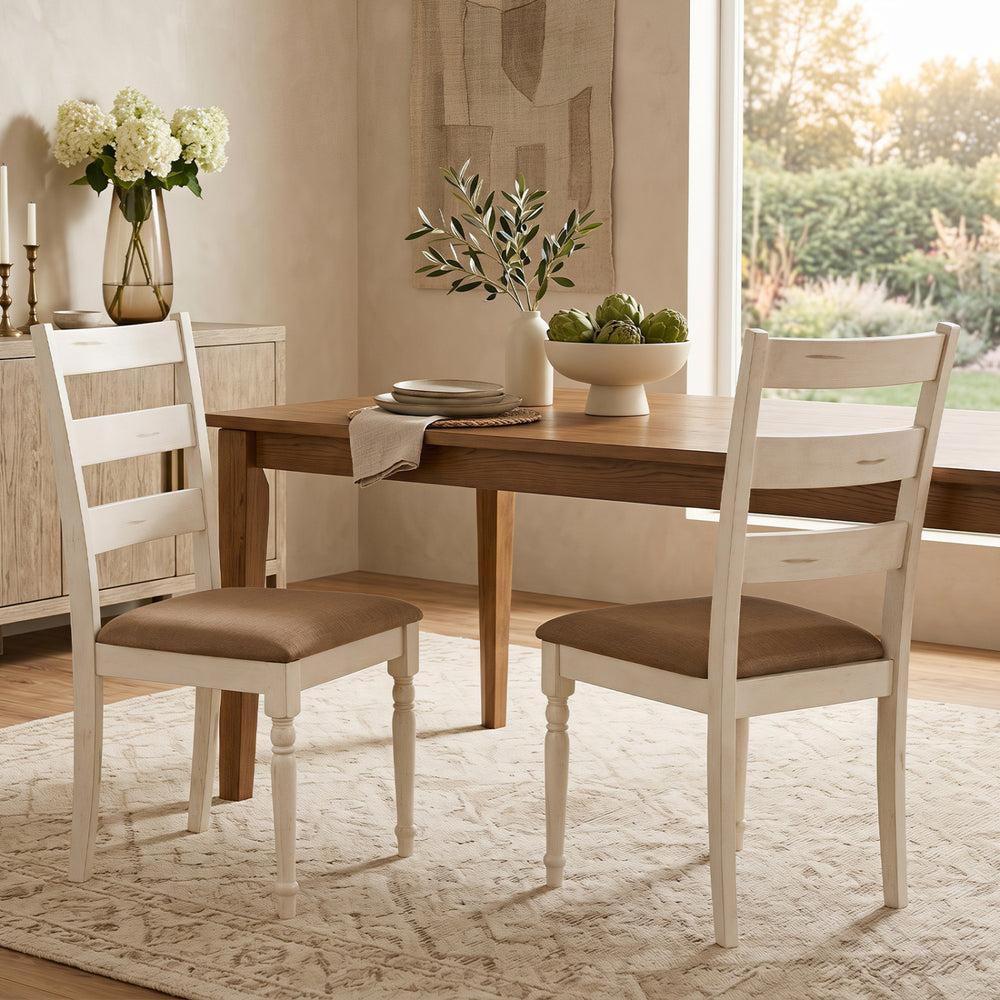 Two white rubber wood dining chairs with padded linen seats and slatted backrests, perfect for dining or living room use.