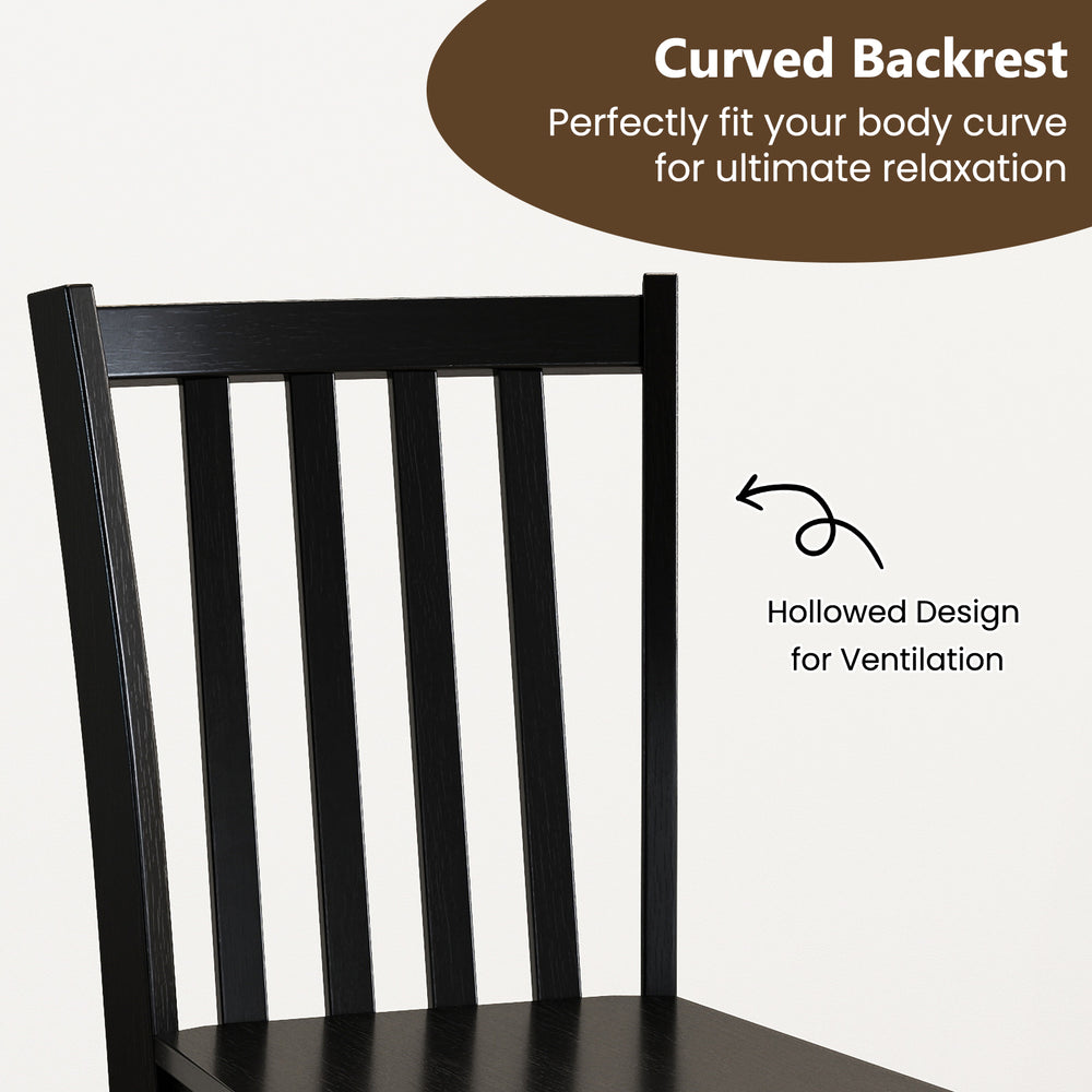 Curved backrest of a black wooden dining chair, designed for comfort and ventilation in a rustic kitchen setting.